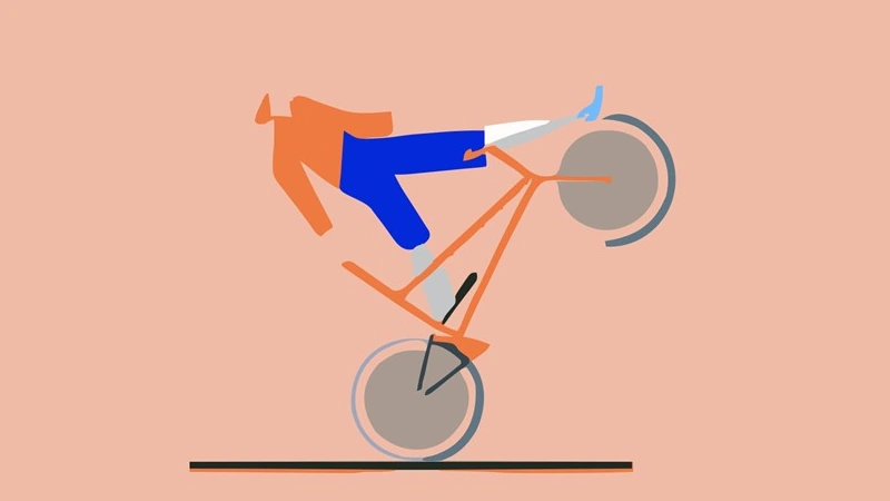 A man riding a bike on its side and about to have an accident