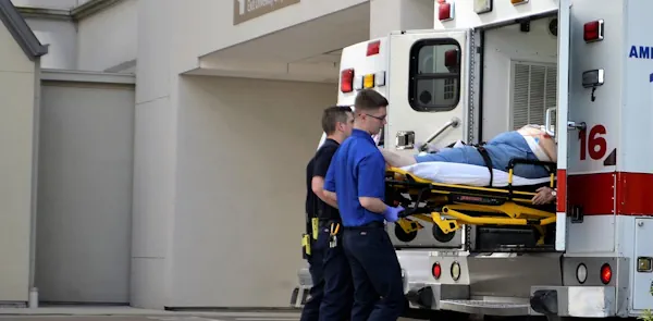 First responders loading ambulance with man injured at work